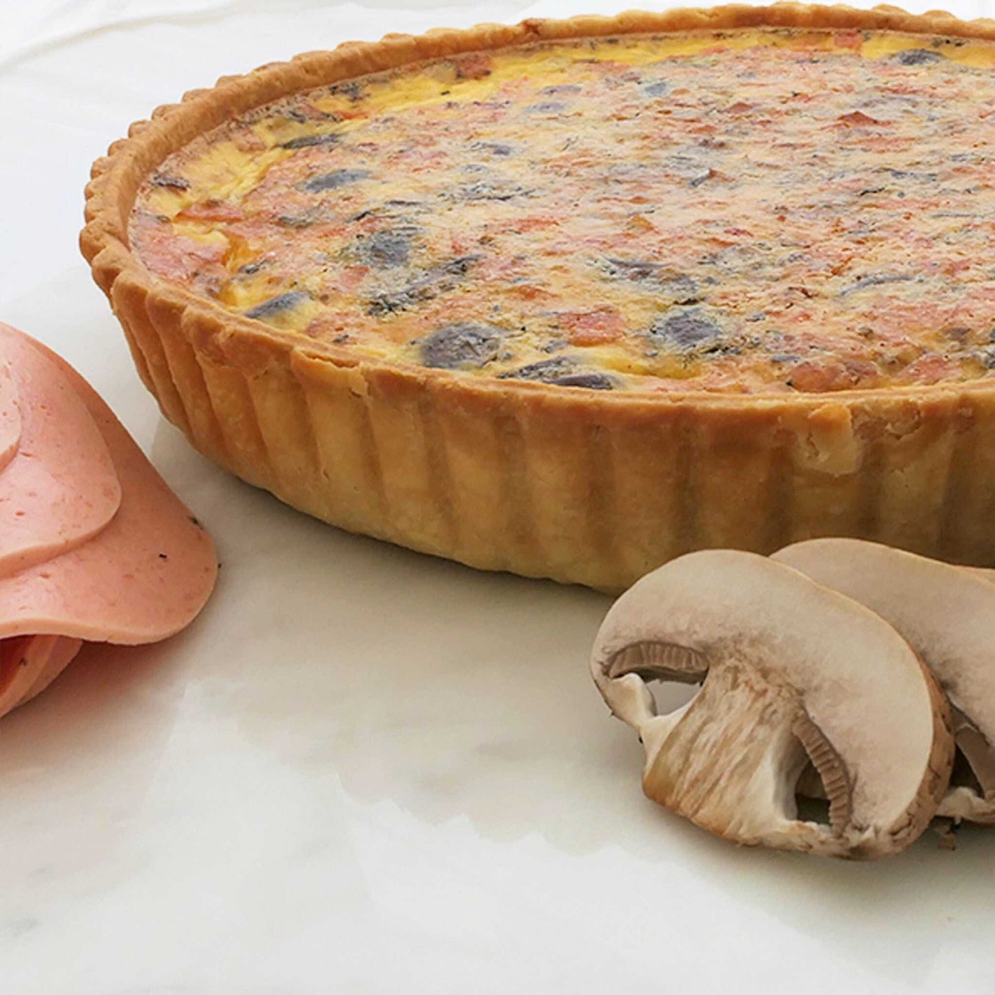 Luscious slices of mushroom, and premium ham and cheeses in an aromatic light custard, set in our signature thin crust. This is a 24cm quiche.