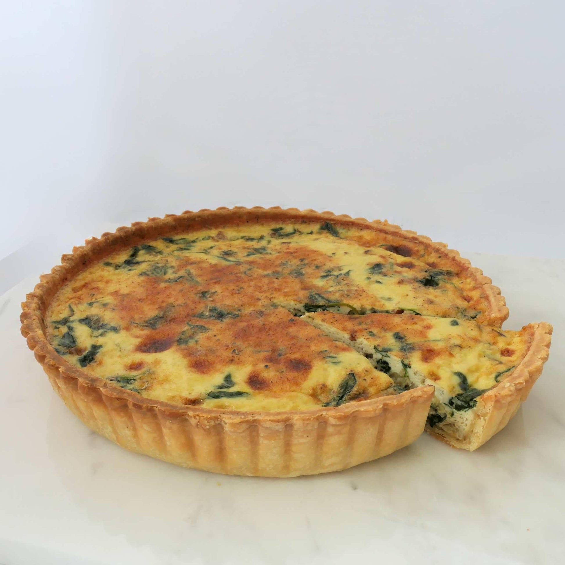 Fresh baby spinach, premium bacon strips and cheeses in an aromatic light custard, set in our signature thin crust. This is a 24cm quiche.