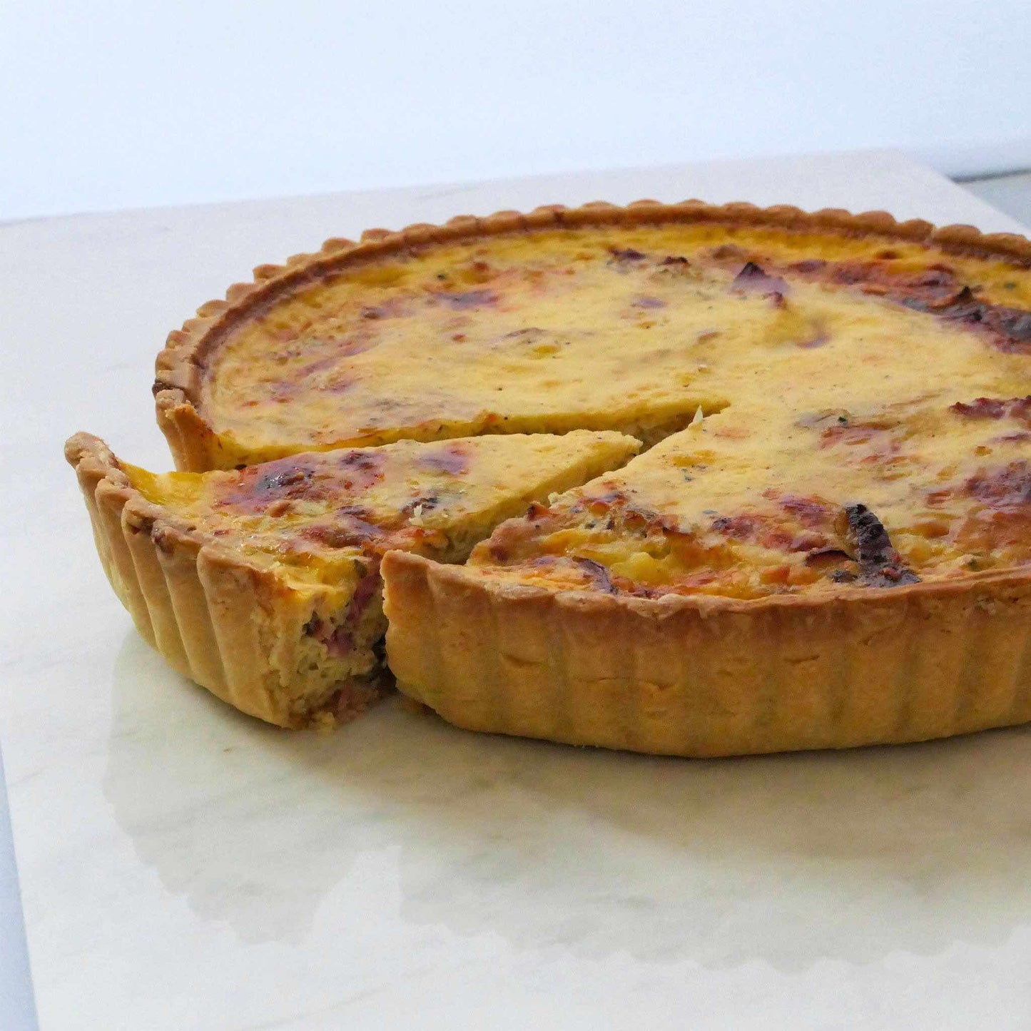 Lovely smoked duck, fragrant leeks and premium cheeses in an light aromatic custard, set in our signature thin crust. This is a 24cm quiche.