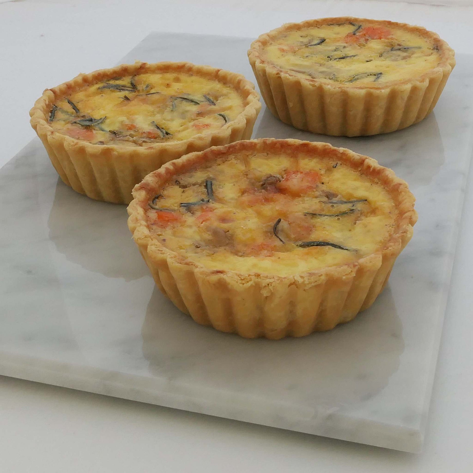 Savoury smoked salmon, sweet caramelised onions and premium cheeses in an aromatic light custard, set in our signature thin crust. These are 10cm quiches.