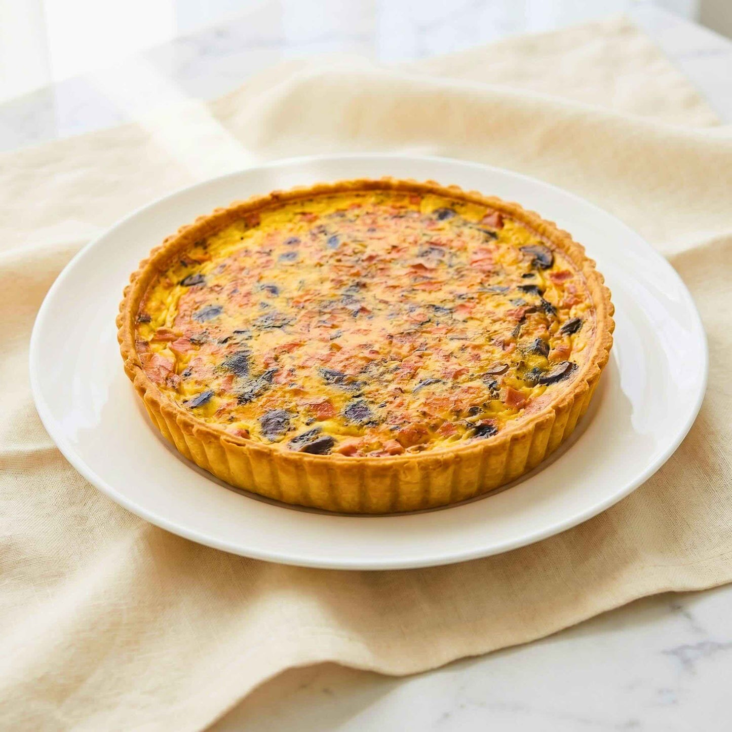 24cm family Mushroom and Ham Quiche on white porcelain plate with golden thin crust and creamy custard filling, Carpina Bakery Singapore