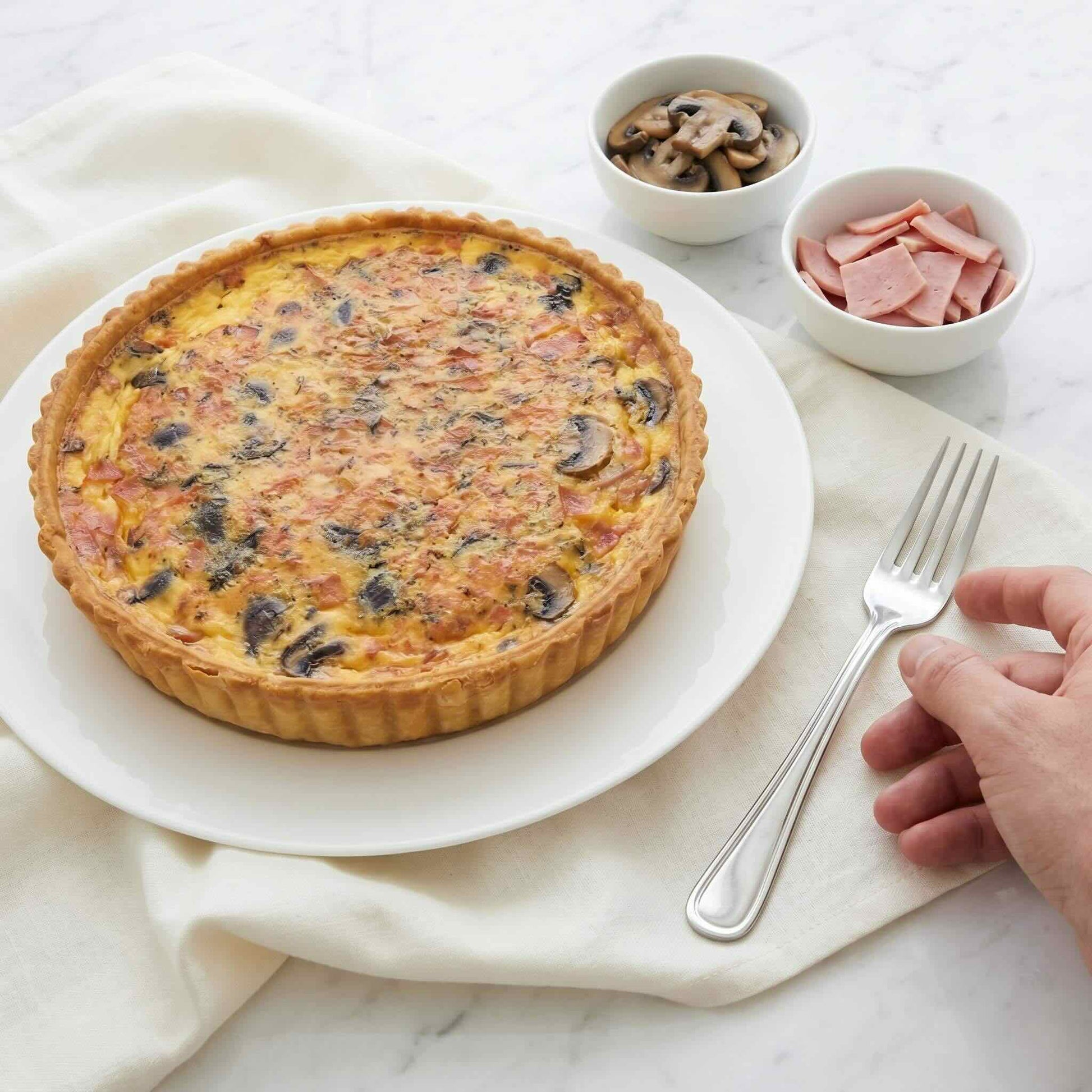 Mushroom and Ham Quiche on white plate with small bowls of sautéed mushrooms and sliced ham beside it, 24cm family size, Carpina Bakery Singapore