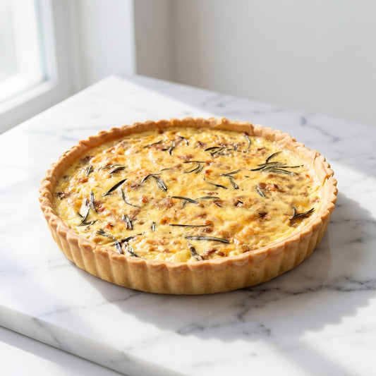 Whole Smoked Salmon and Caramelised Onion Quiche on white marble with fresh rosemary sprigs and golden thin crust, 24cm family size, Carpina Bakery Singapore